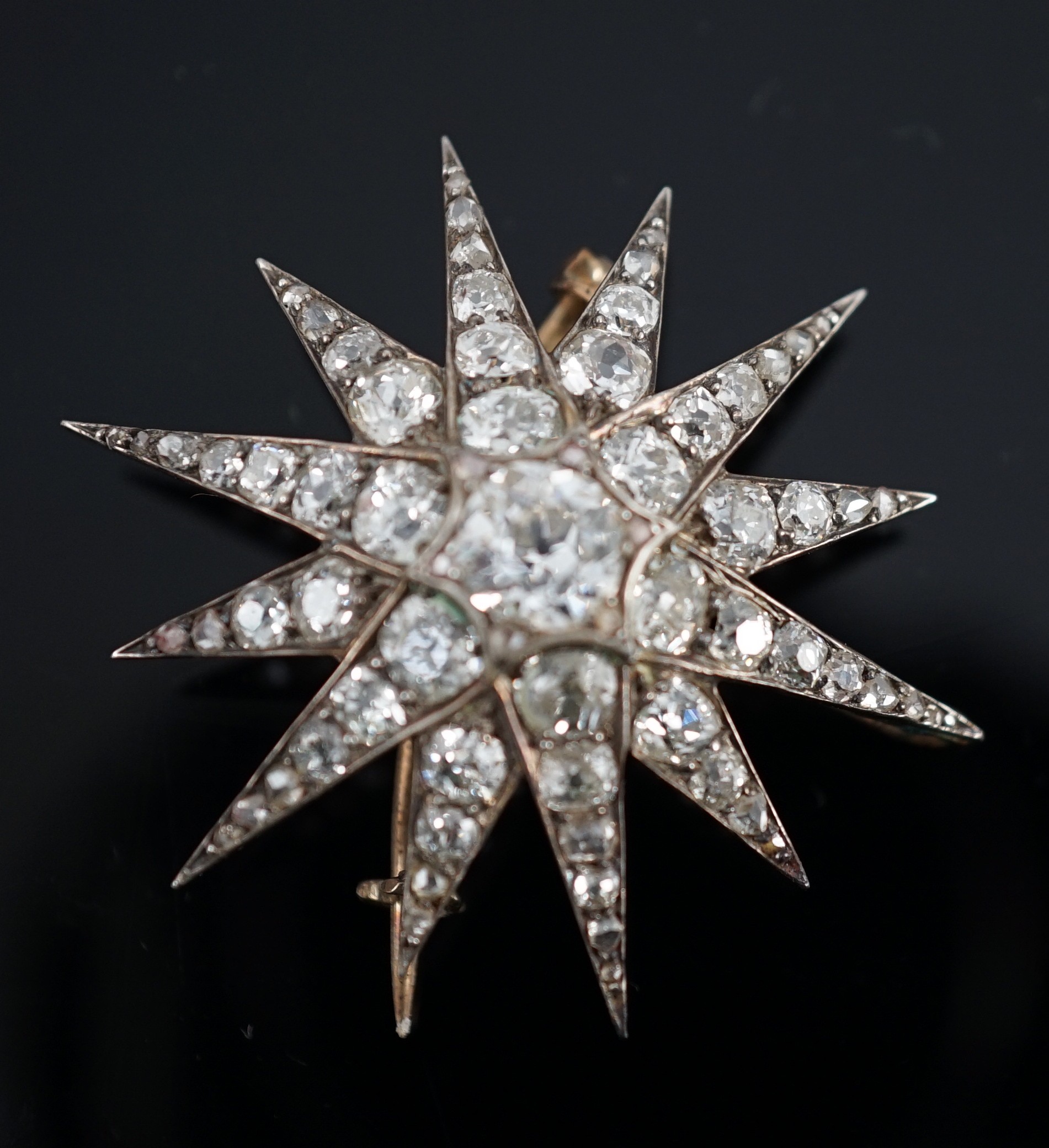 A Victorian gold, silver and graduated old cut diamond set starburst brooch